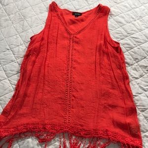 Orange tank top with fringe hem.
